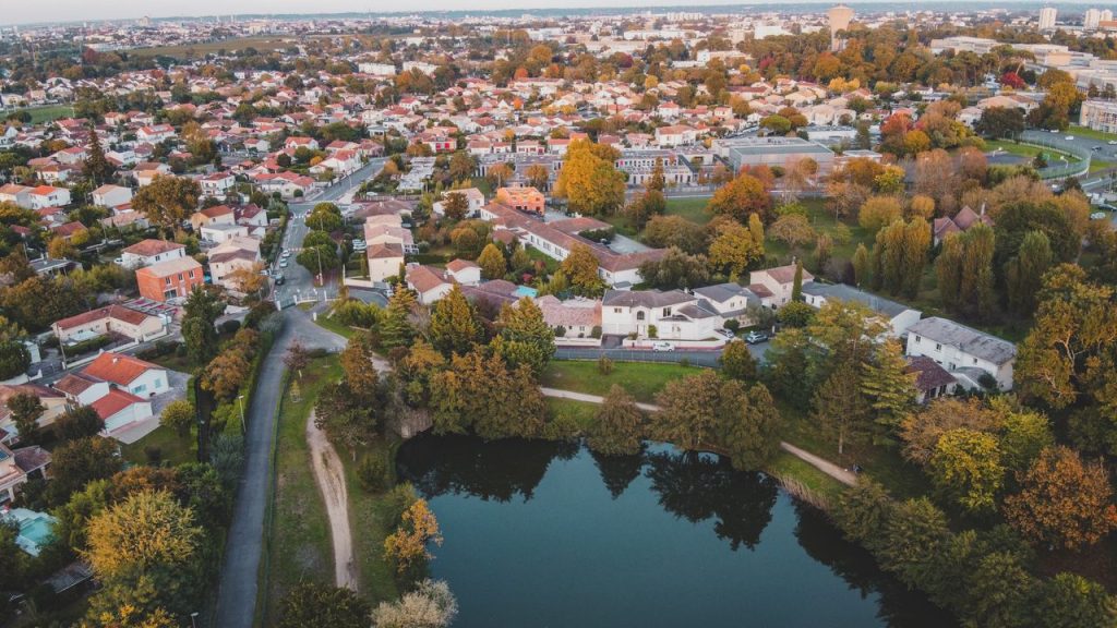 Scenic aerial view of Bordeaux, France showcasing residential areas and lush greenery during fall.